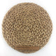A finely woven, round abaca placemat in a warm honey tone, showcasing natural texture and elegant artisan craftsmanship.