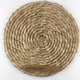Elegant round placemat crafted from silver-toned abaca, showcasing refined spiral weave and superior natural fibre craftsmanship.